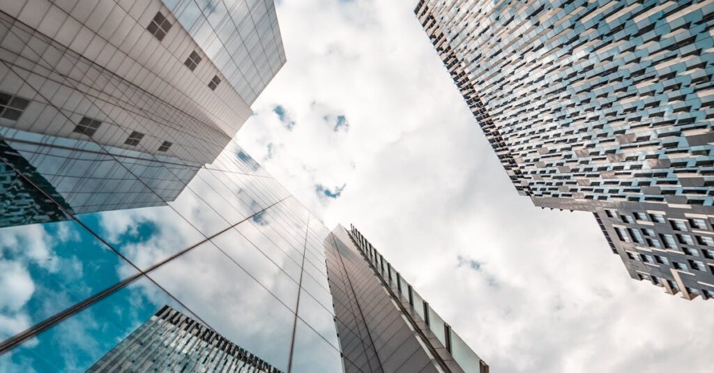 Low angle view of modern skyscrapers reflecting the cloudy sky in Brussels, Belgium.